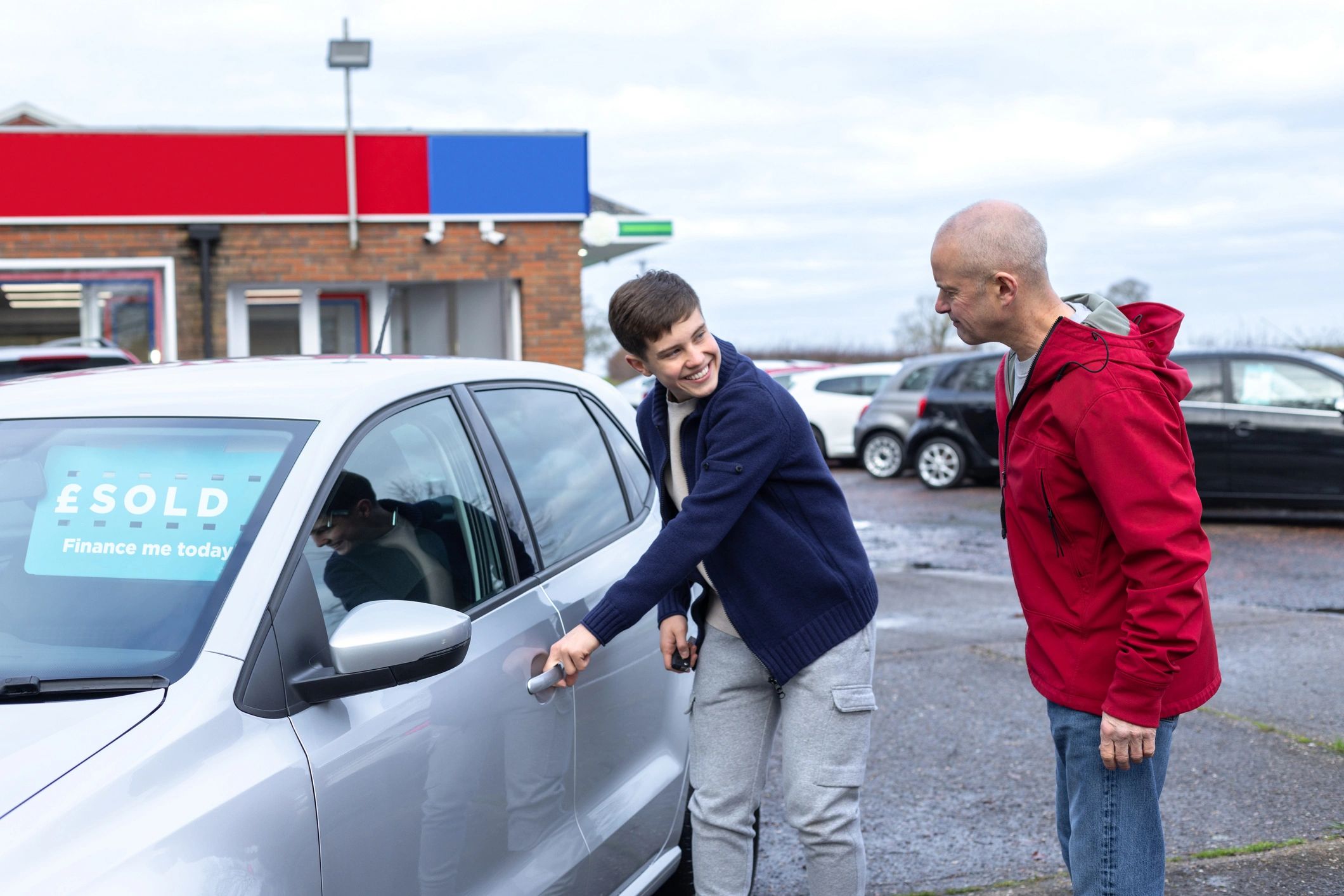 Customer standing beside a vehicle