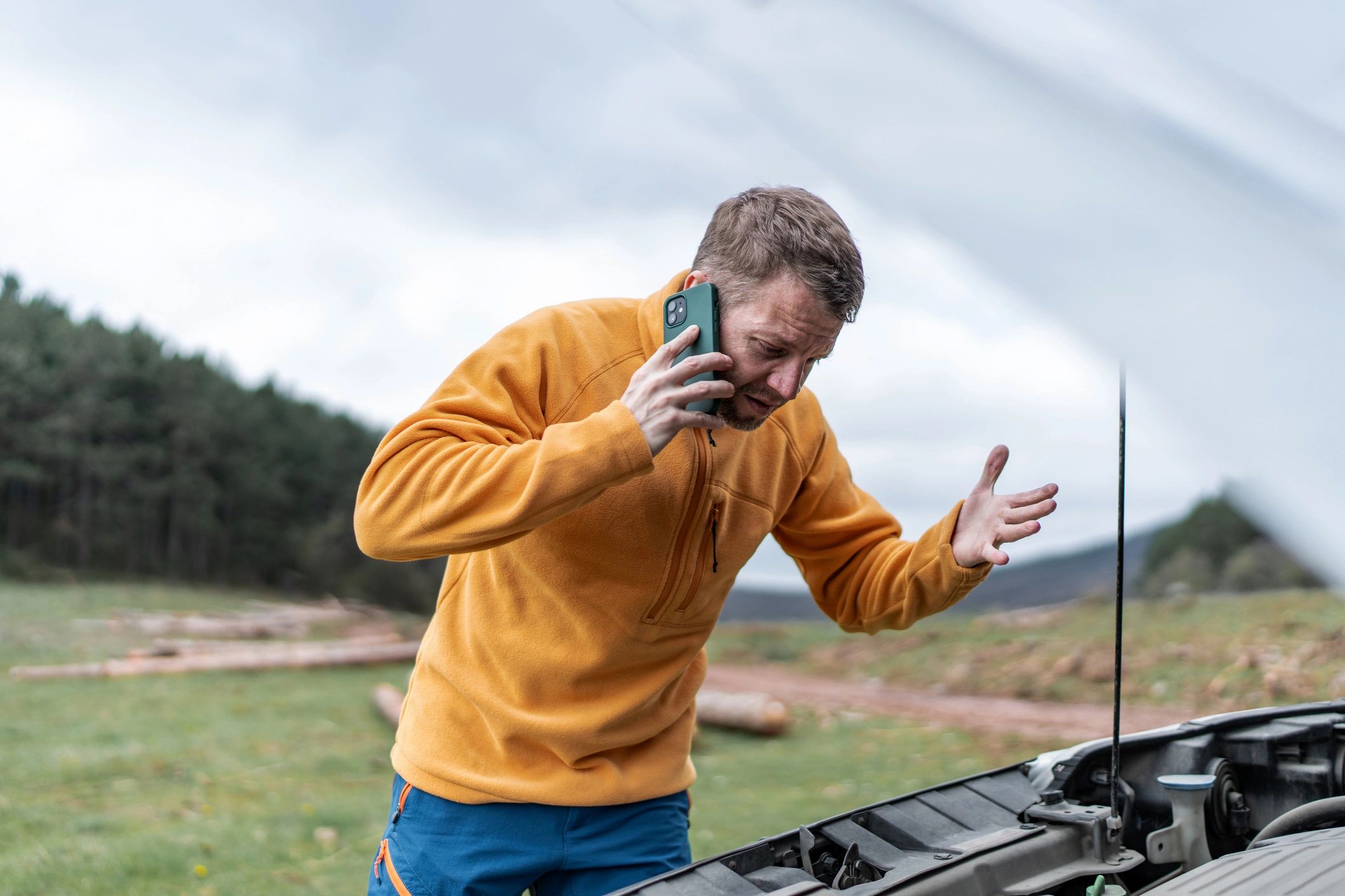 Customer beside a broken down car calling for help